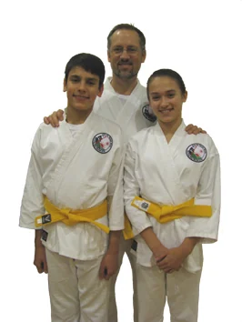 The instructor with two Morning Star students in karate uniforms